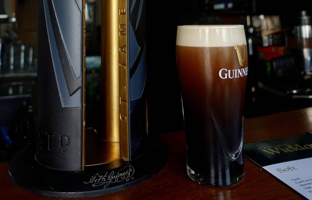 Photo d'une bière Guiness et d'une tireuse à bière.